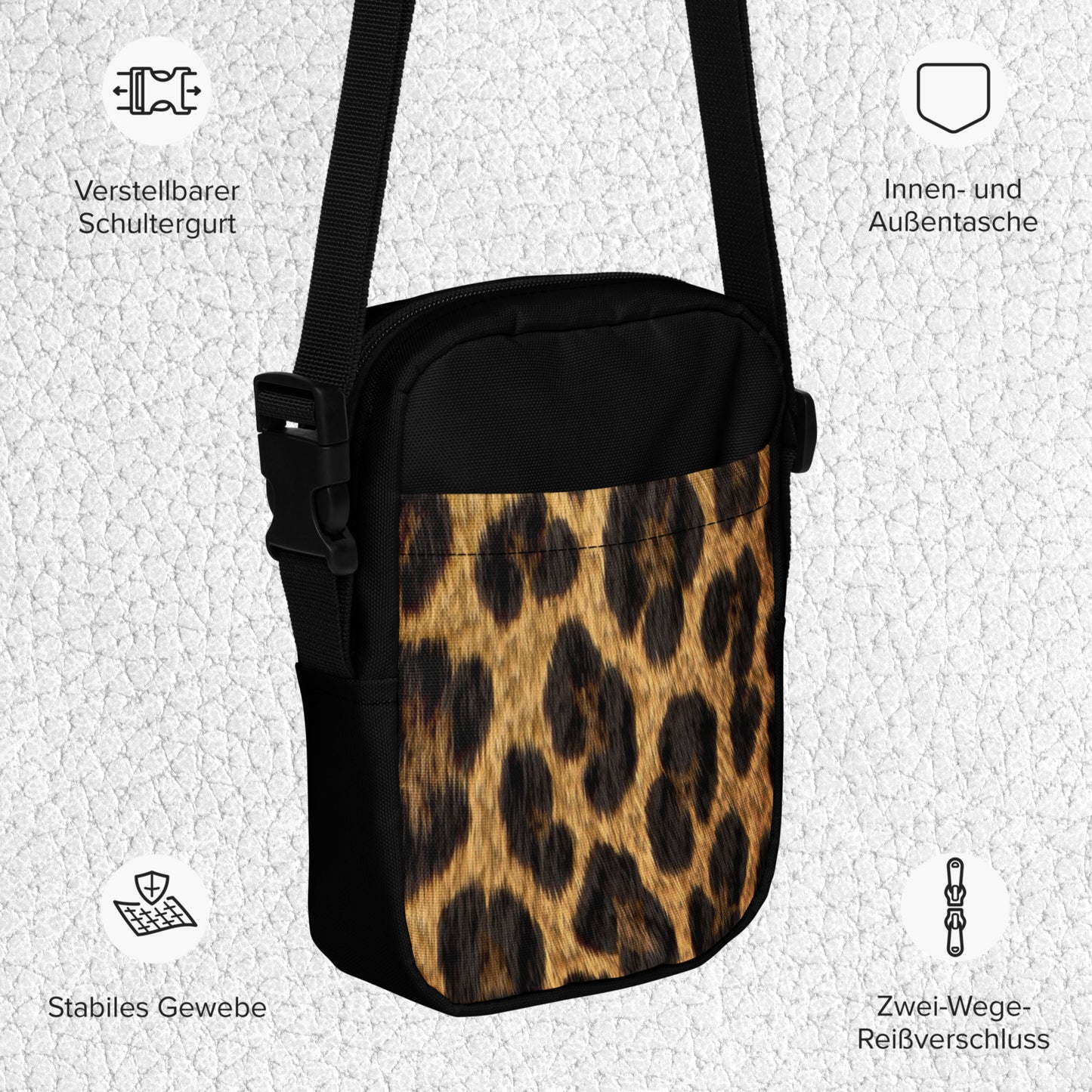 Produktdetails deutsch der kompakten Crossbody Bag mit funktionalen Fächern, verstellbarem Schultergurt, zwei Wege Reißverschluss und Vorderseite bedruckt mit kontrastreichem Jaguarfell-Muster. Innen- und Außentasche ebenfalls enthalten