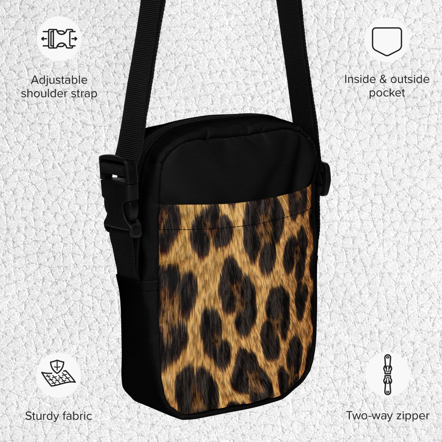Product details for the Jaguar crossbody bag. This compact crossbody bag features practical compartments, an adjustable shoulder strap, a two-way zipper, and a front panel with a high-contrast Jaguar print. It also has one interior and one exterior pocket.