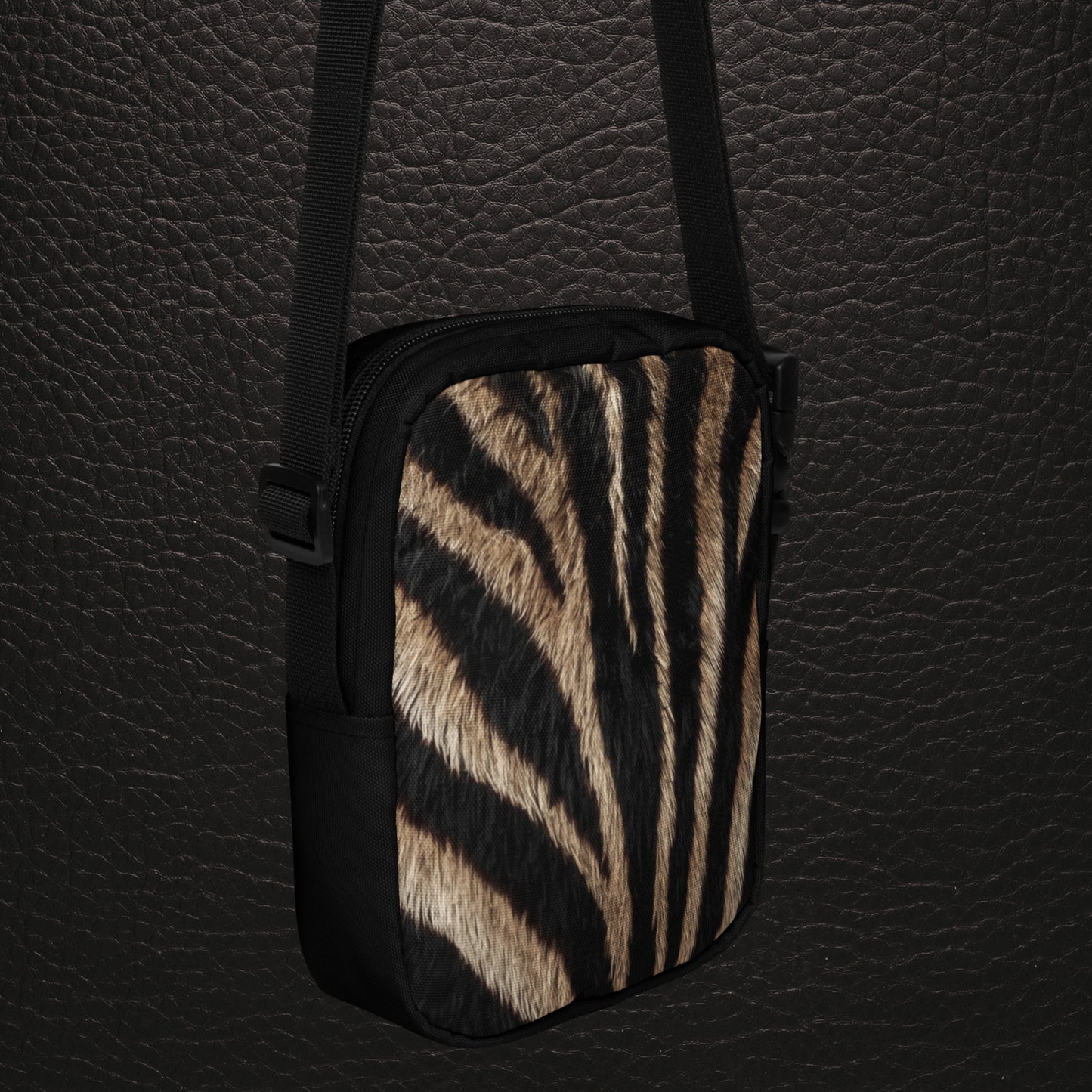 Schrägansicht der Rückseite der kompakten Zebra Muster Umhängetasche mit natürlichem Fellprint und schwarzem Trageriemen