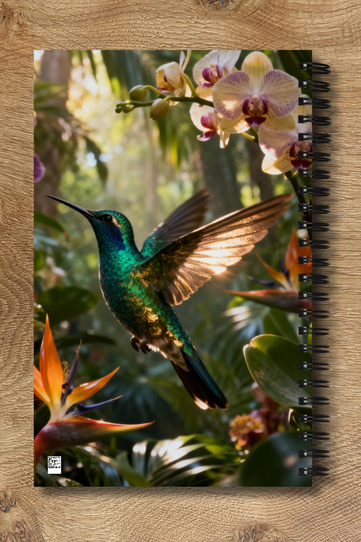 Spiralnotizbuch mit schillerndem Kolibri vor tropischer Regenwaldkulisse als Rückseitenansicht mit harmonisch fortgeführtem gespiegeltem Motiv.