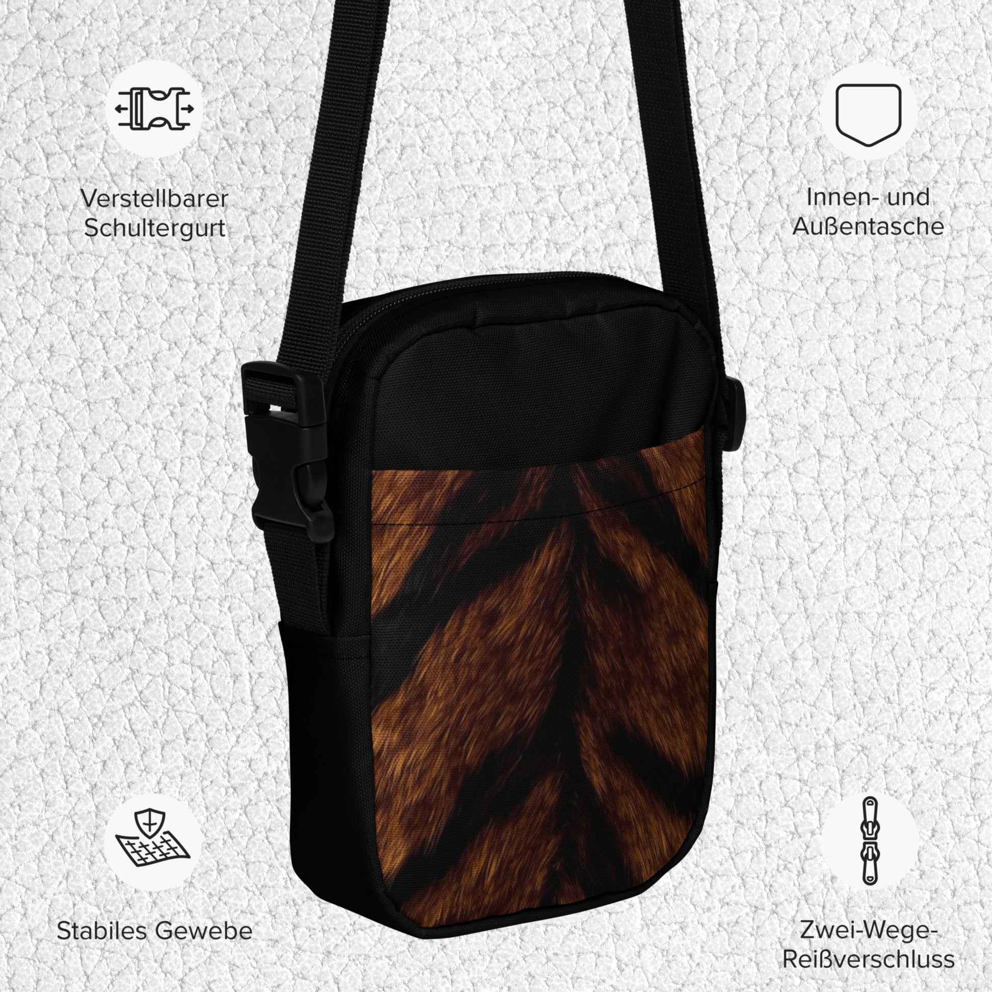 Produktdetails der Tigerfell Crossbody Bag in deutscher Sprache mit verstellbarem Schultergurt, Innen- und Außentasche sowie stabilem Gewebe