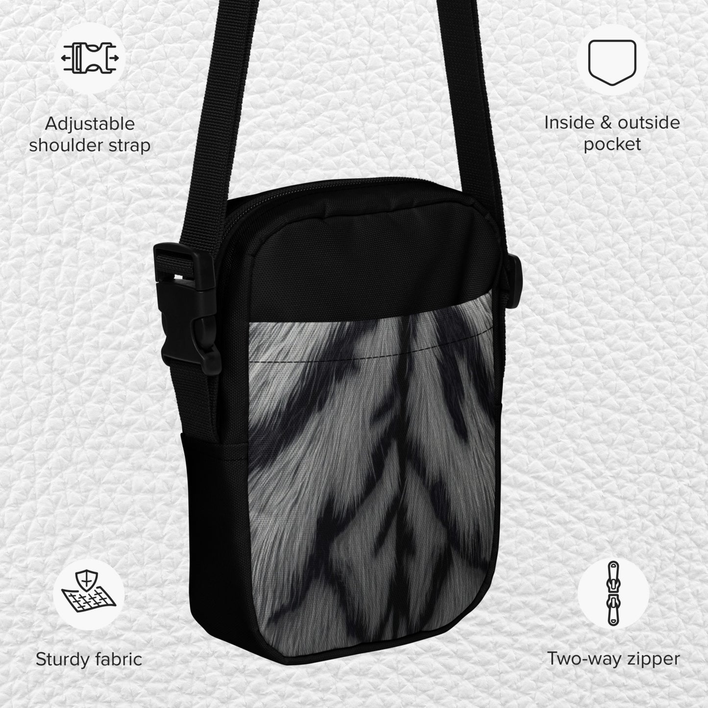 Product details of the white tiger crossbody bag with adjustable shoulder strap, inside and outside pockets, and two-way zipper